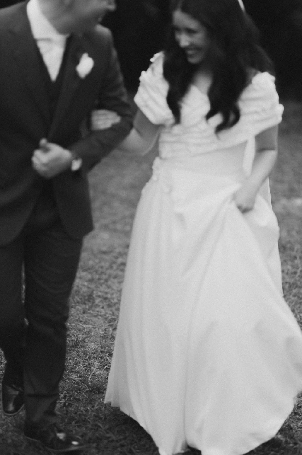 Black and white photo series showing the flow of a white wedding dress as the couple dances at their reception.
