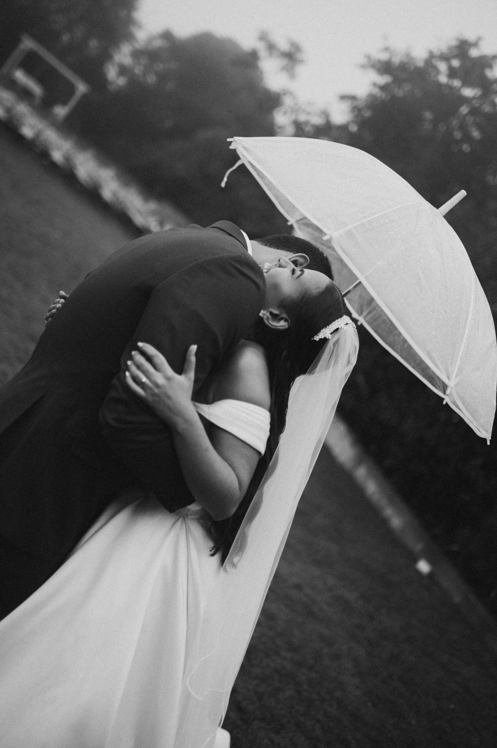 A series of artistic black and white photos showing a white umbrella against a dark background.