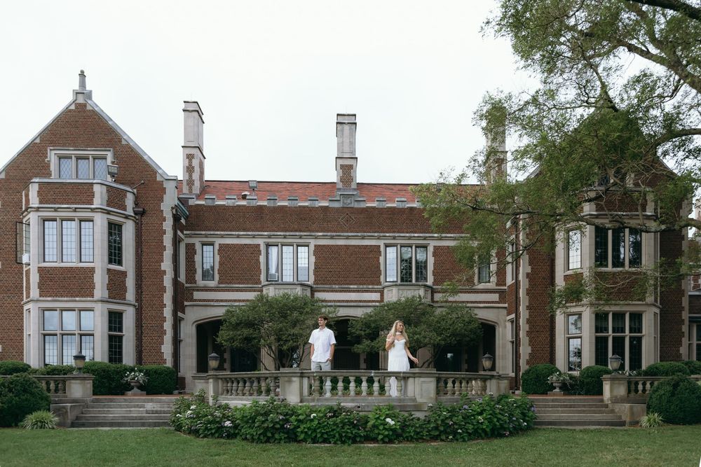 Panoramic shot of a grand historic brick estate building with ornate architectural features.