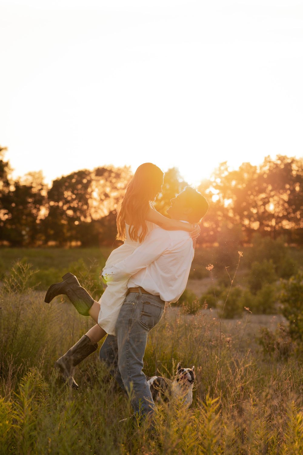 Golden hour sunset with an engaged couple kissing