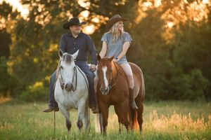 man and woman sitting horseback in a field at sunset, equestrian portraits, Chandler, Texas
