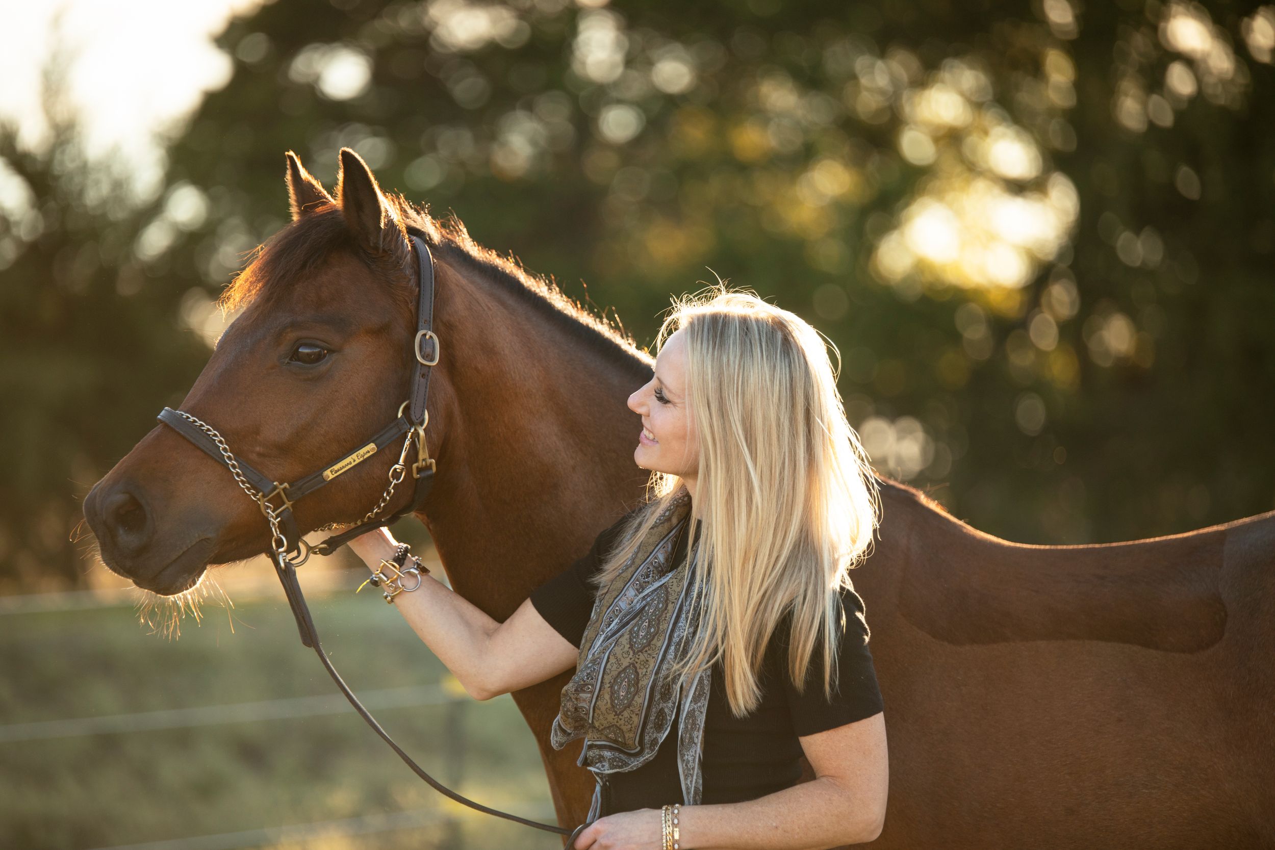 woman standing next to horse during equestrian photoshoot in Cedar Hill, Texas