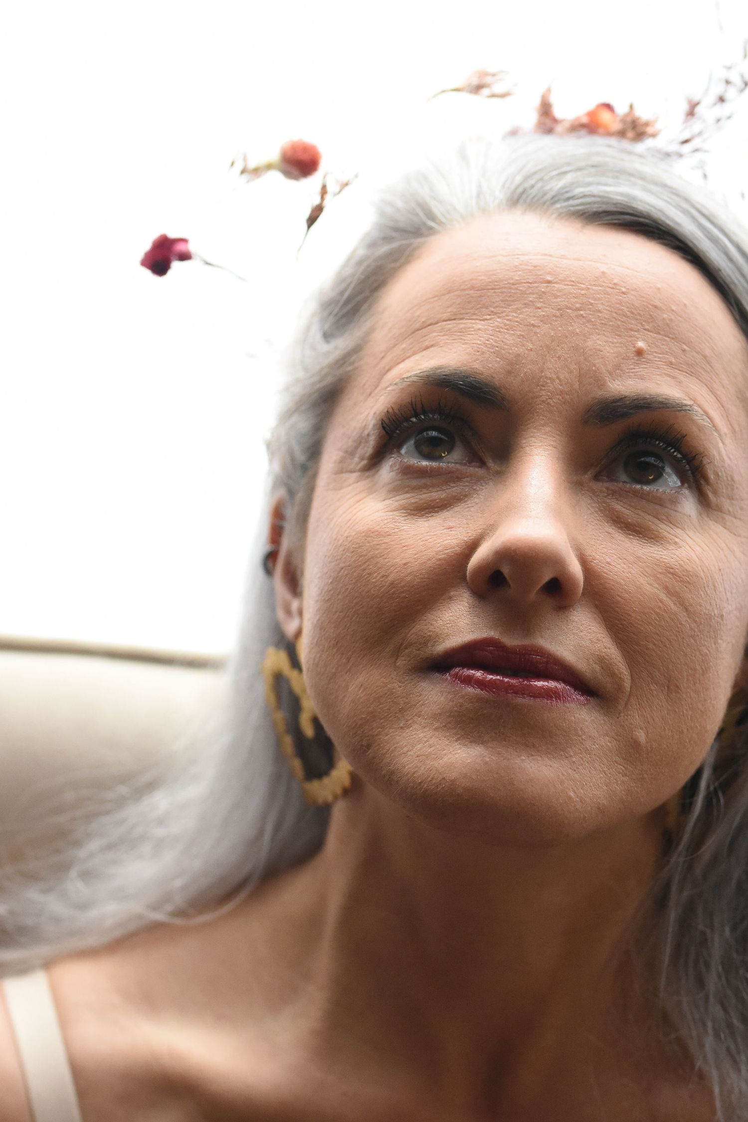 A series of close-up portrait shots showing different angles and expressions with silver-gray hair.