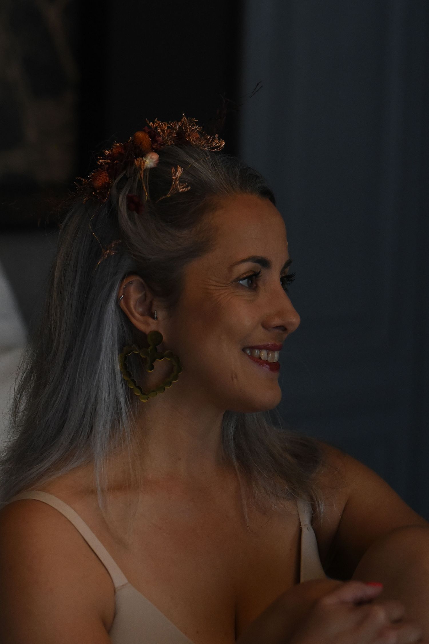 A bride in a white dress and veil smiles joyfully in a series of candid wedding day portraits.
