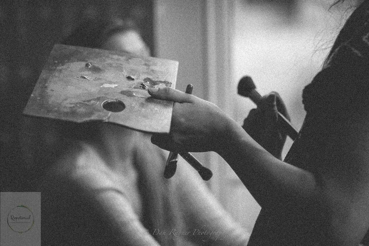 Reportage detail shot of make up assistant (MUA) applying make up to bridesmaid