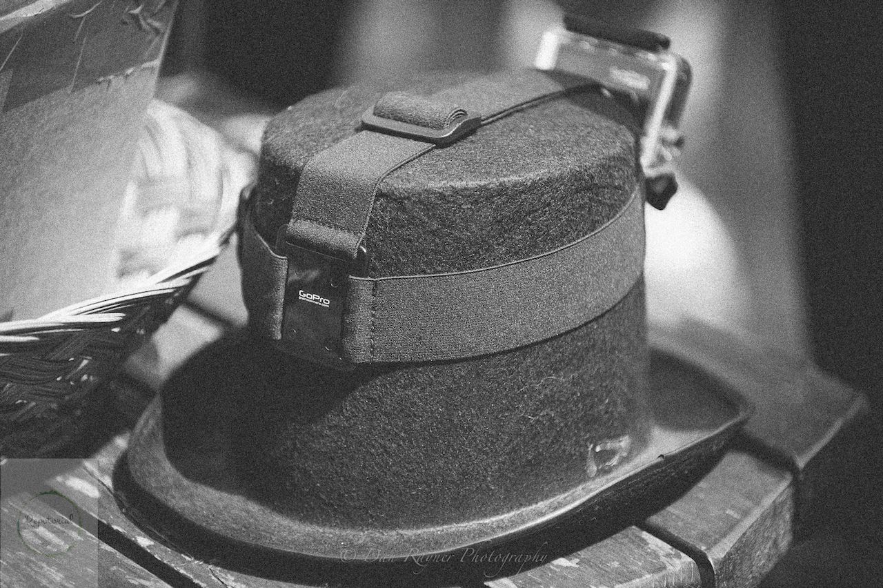 Reportage detail shot of go pro on wedding morning suit top hat