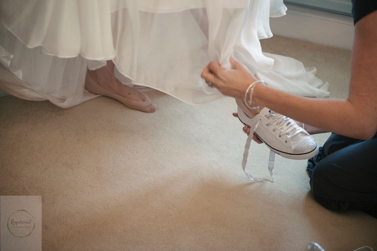 Reportage detail shot of brides shoes - trainers