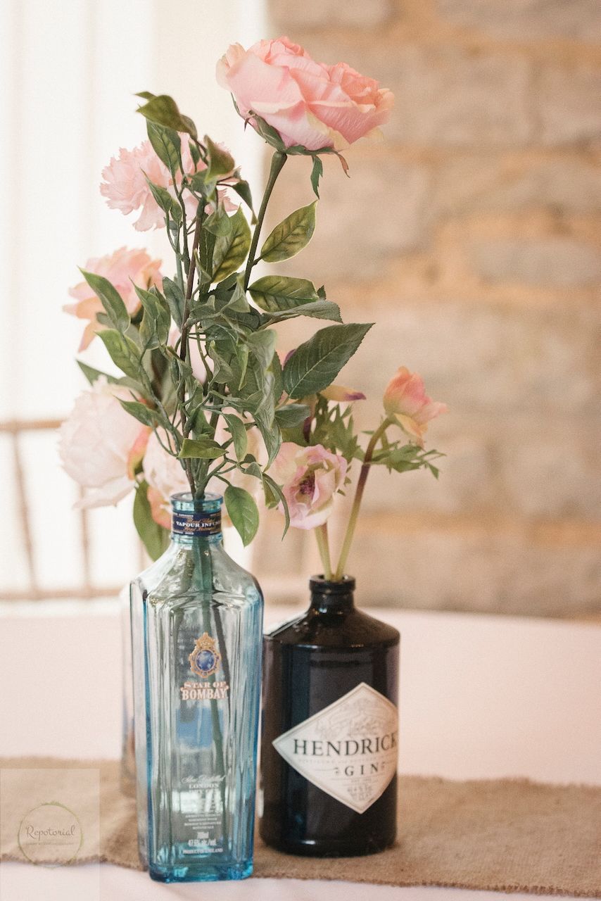 Reportage detail shot of gin bottle being used as a flower vase