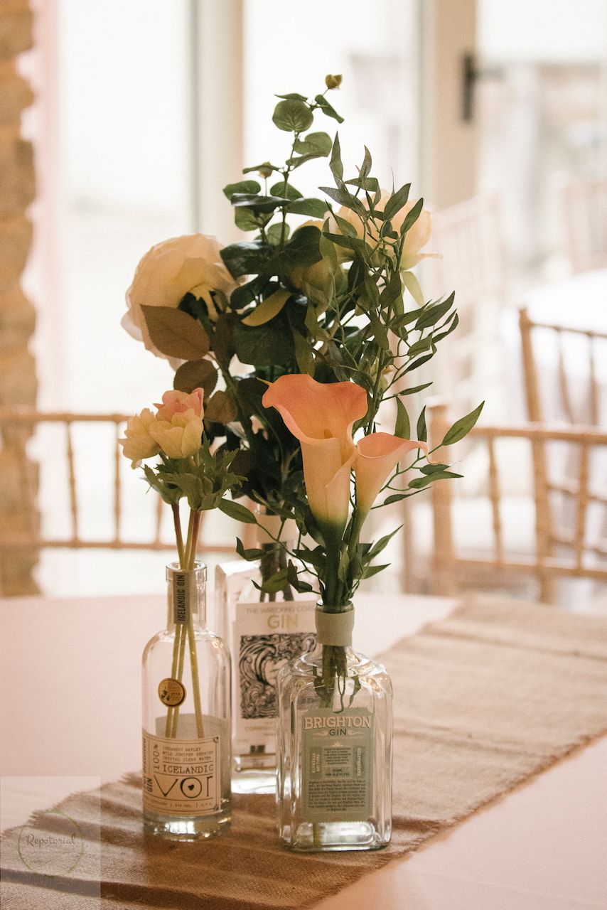 Reportage detail shot of gin bottle being used as a flower vase