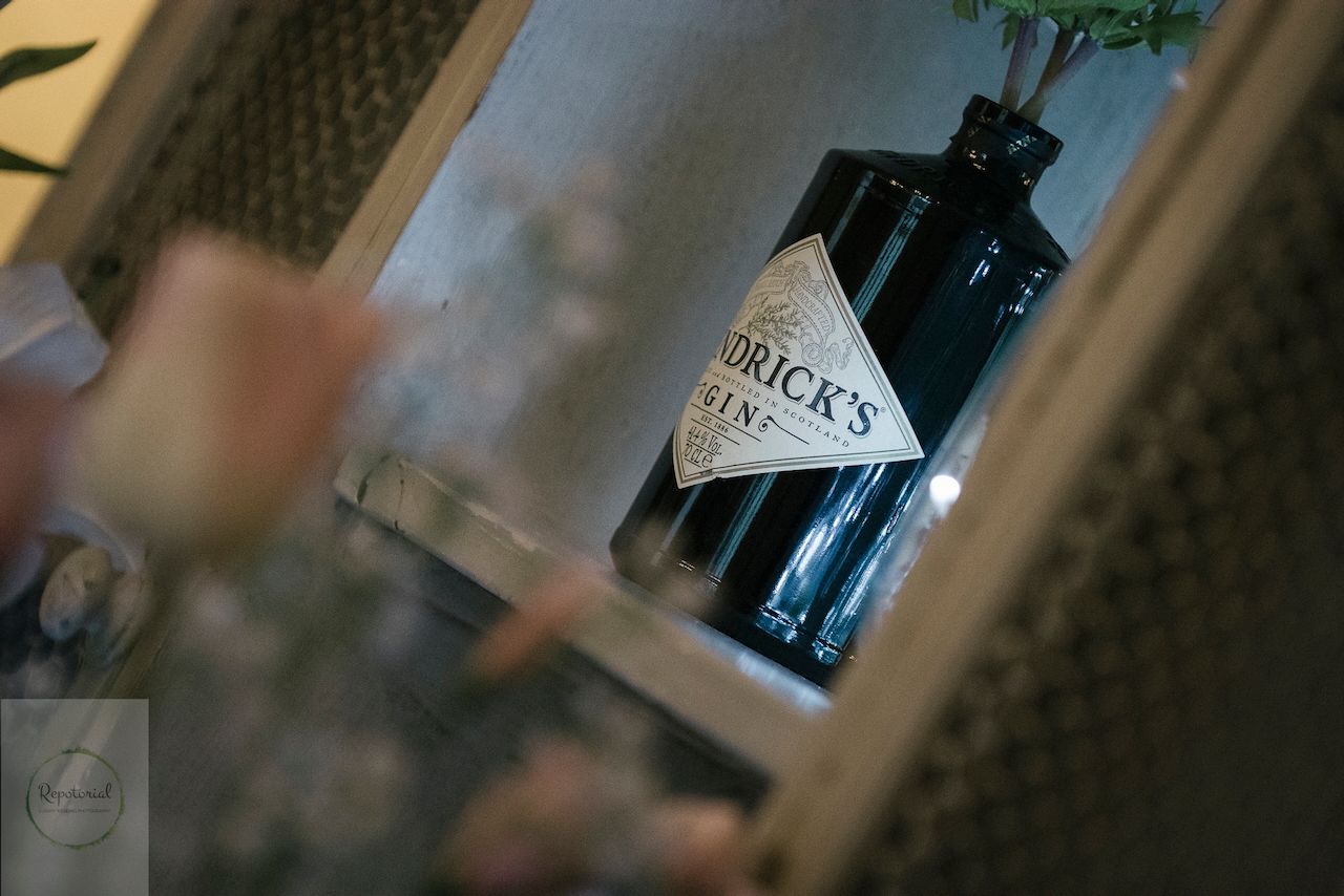 Reportage detail shot of gin bottle being used as a flower vase