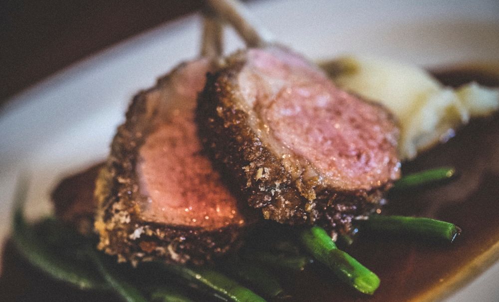 Reportage detail shot of wedding breakfast roast lamb