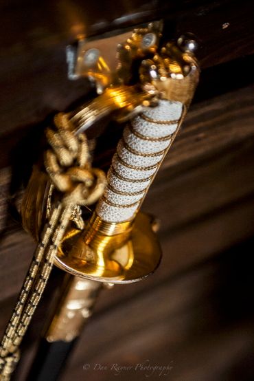 Reportage detail shot of military officers sword at bar
