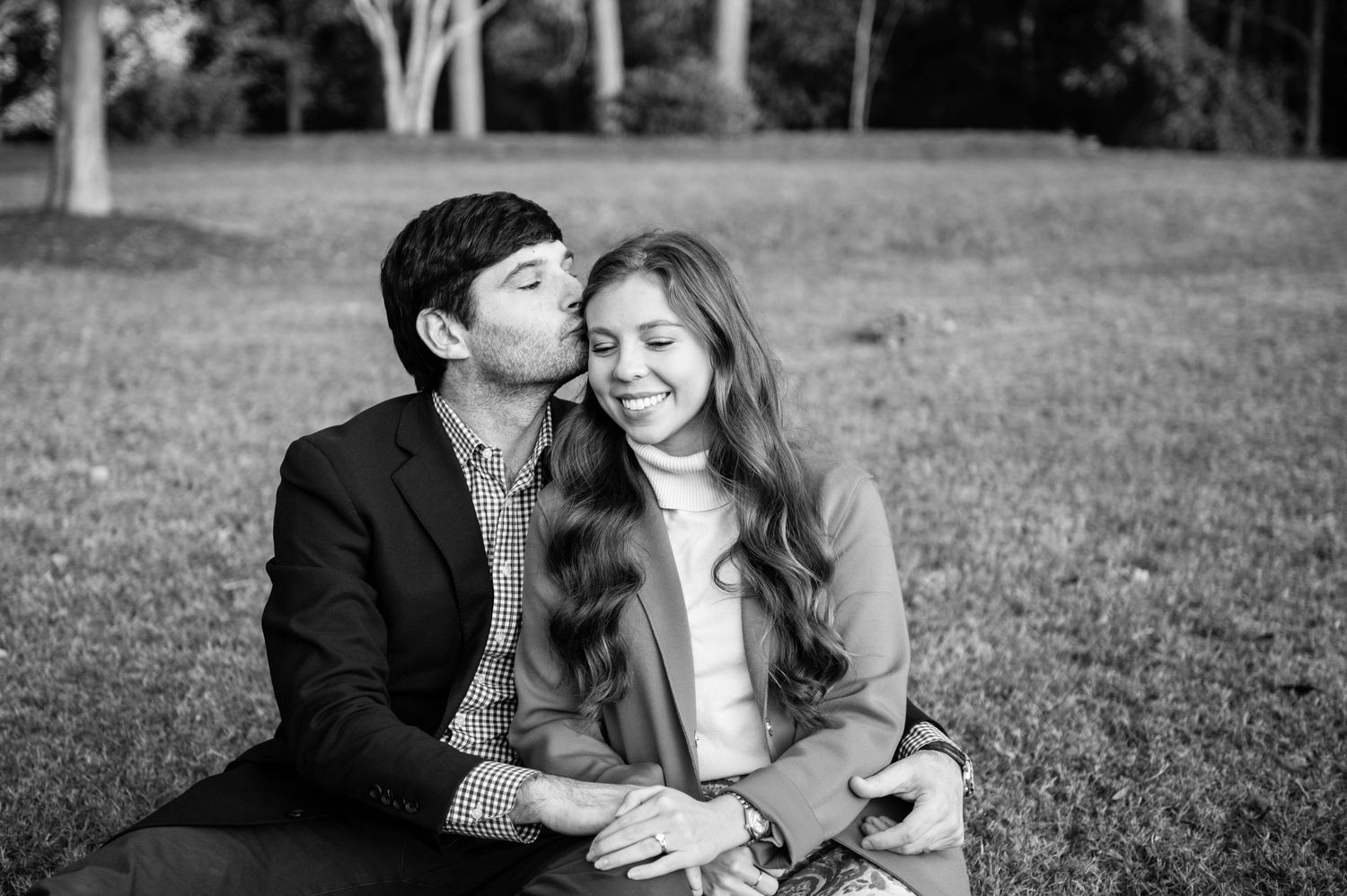 A romantic black and white photo sequence captured on grassy field.