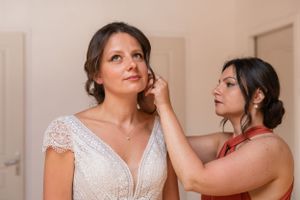 Wedding preparation moments captured in a warm-toned indoor setting.