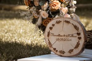 Wooden wedding signage with names and date burned into rustic wood slices.