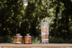Glass lanterns and decorative elements arranged on an outdoor table setting.