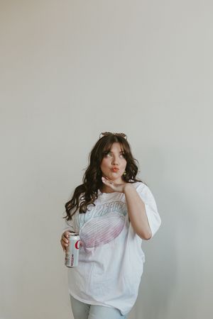 A series of aesthetic photos showing a person in a white t-shirt with Coca-Cola branding posing against a light background.