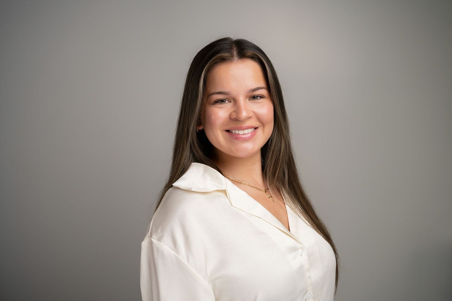 Orlando headshot photographer Ray Alvarez — entrepreneur headshot with clean gray background and professional white blouse