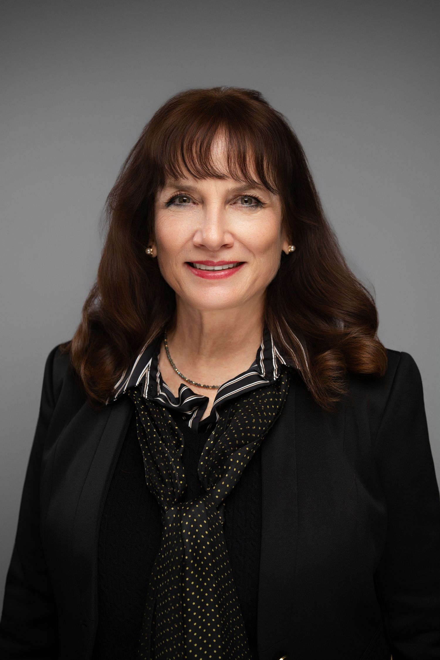 Orlando headshot photographer Ray Alvarez — senior professional headshot for female executive in dark blazer