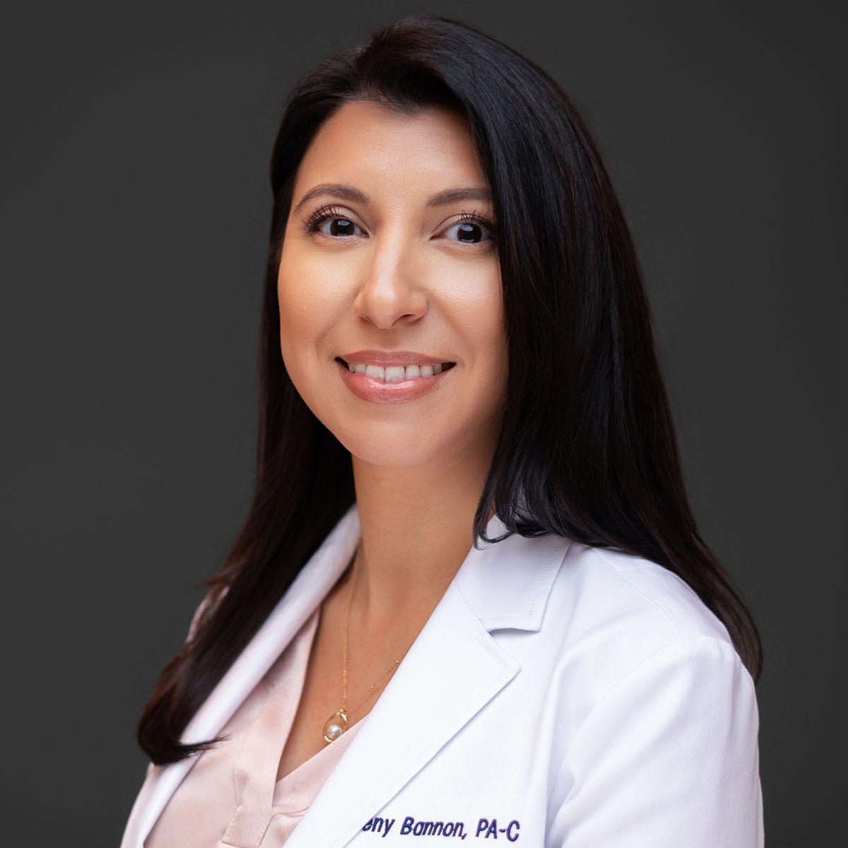 Orlando headshot photographer Ray Alvarez — physician assistant headshot in white coat with professional studio lighting
