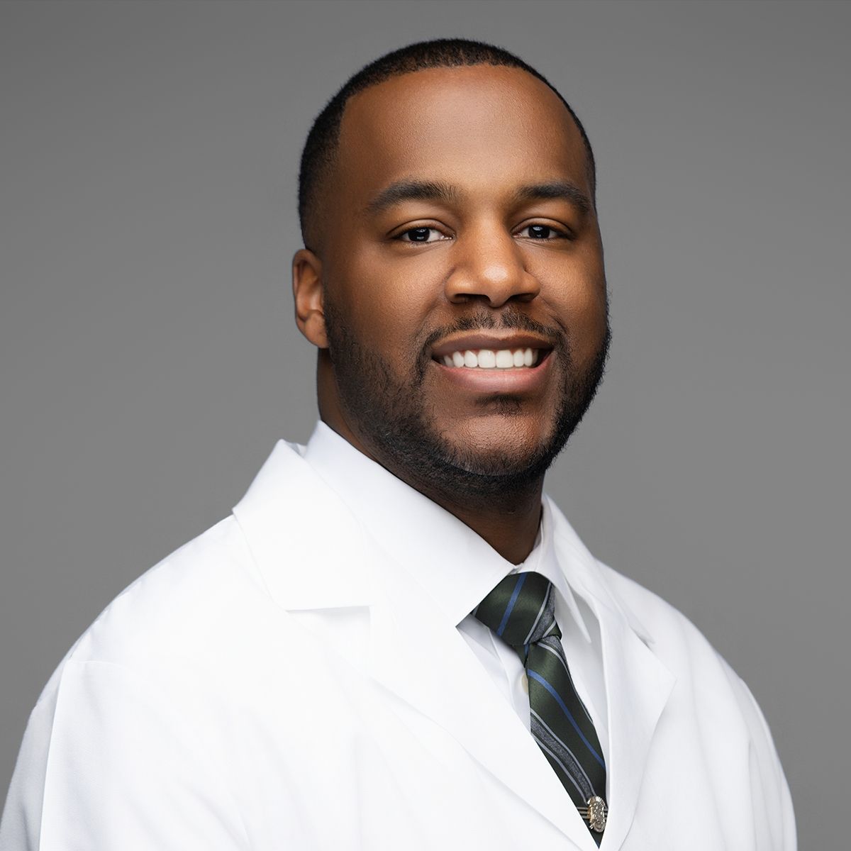 Orlando headshot photographer Ray Alvarez — physician headshot in white coat with professional studio lighting