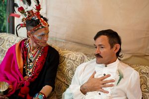 Wedding gathering with traditional colorful attire and decorative elements.