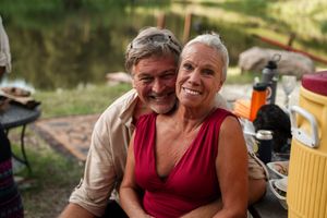 Guests share intimate moments at an outdoor summer celebration.