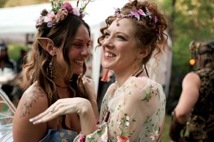 Joyful expressions shared between guests at outdoor wedding celebration.