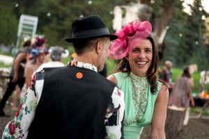 Wedding guests socializing and celebrating at outdoor garden party.