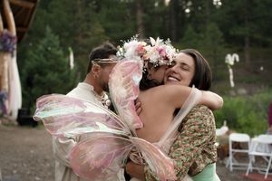 Celebratory moment captured during an outdoor forest wedding reception.
