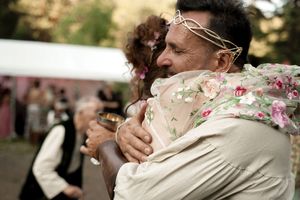 Joyous embraces and celebrations at an outdoor wedding event.