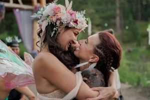 Romantic outdoor wedding moment set against a natural forest backdrop.