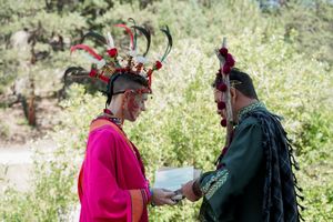 Guests in colorful medieval attire interacting at an outdoor celebration.