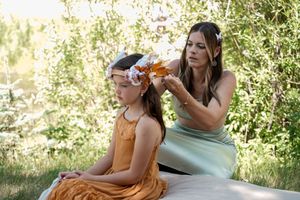 Guests enjoying a casual moment on a sunny hillside during an outdoor celebration.