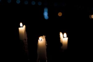 Several glowing candles illuminating a dark space creating a warm ambiance.