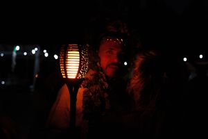 Paper lantern illuminating a romantic nighttime gathering.