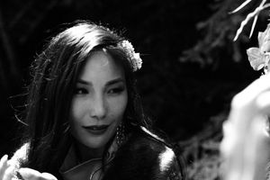 Artistic black and white portrait in dramatic lighting and shadows.