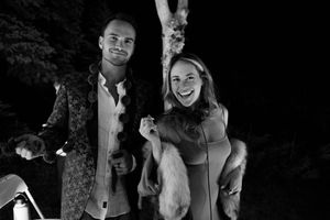 A black and white photo captures joyful moments at an evening celebration.