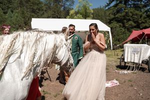 White canvas tents and medieval decorations line an outdoor festival grounds.