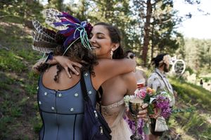 Wedding celebration with vibrant flowers and natural woodland backdrop.