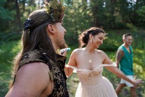 Candid celebrations and dancing during an outdoor forest wedding ceremony.