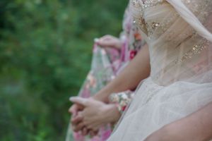 Close-up detail of delicate lace and tulle wedding dress fabric.