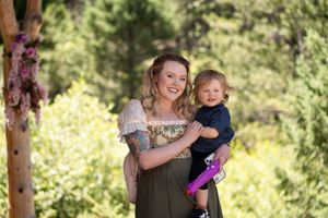 Joyful moments shared during an outdoor wedding reception in a wooded setting.