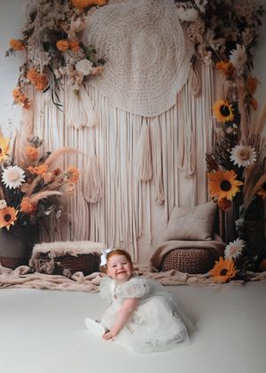 Sequence of rolling and crawling movements on white floor with floral backdrop.