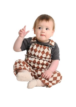 Baby in brown checkered romper lying on white background showing different angles and positions.