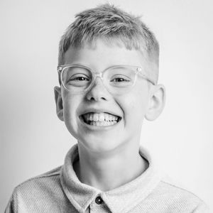 Black and white portrait series showing joyful expressions and genuine smiles.