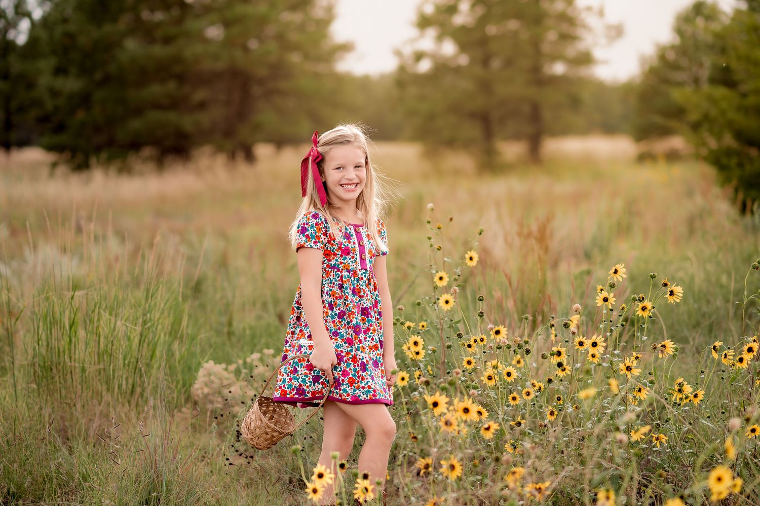 Snow sparkles around a child in winter clothing during golden hour.