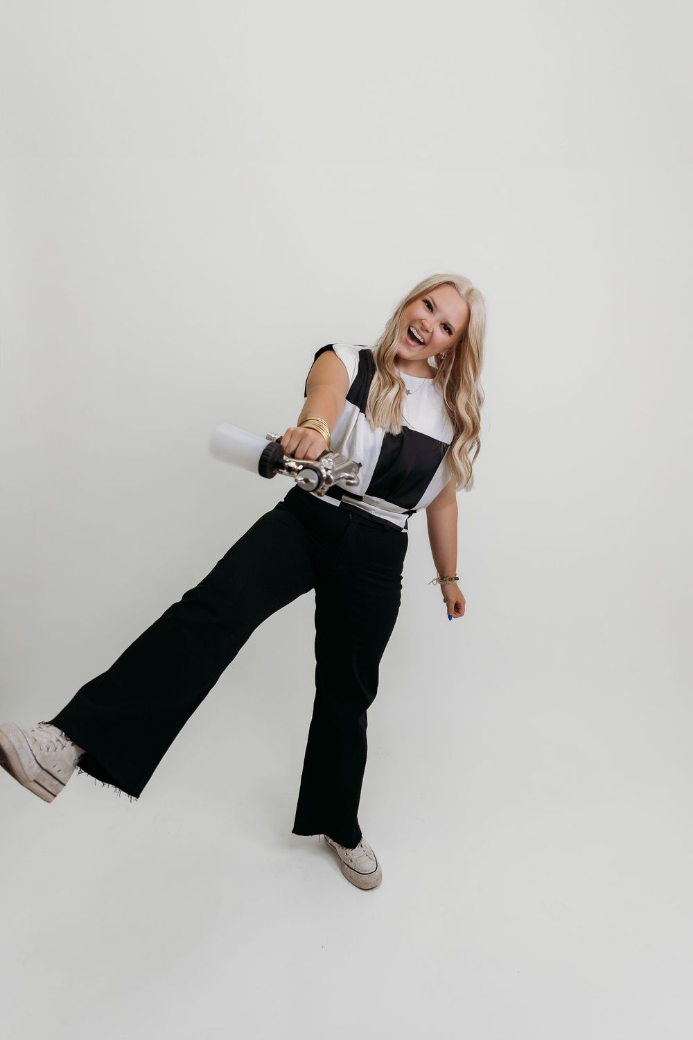 Playful studio photoshoot against white background showing dynamic movement and poses.