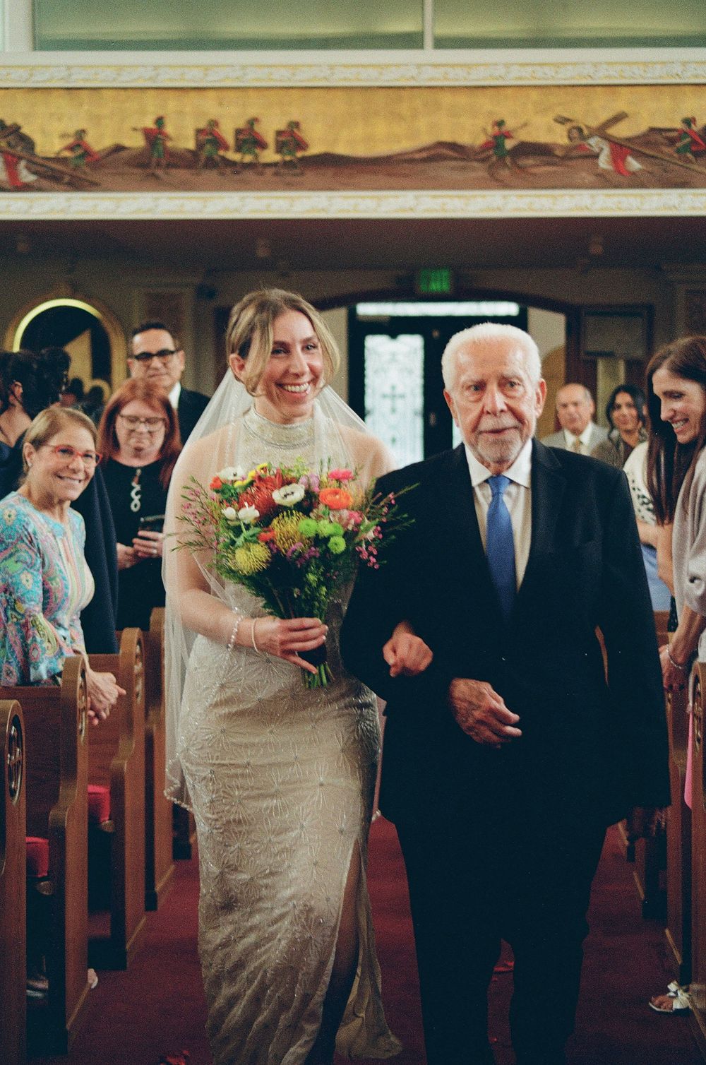 A father walks his daughter down the aisle for her wedding day captured on film photography