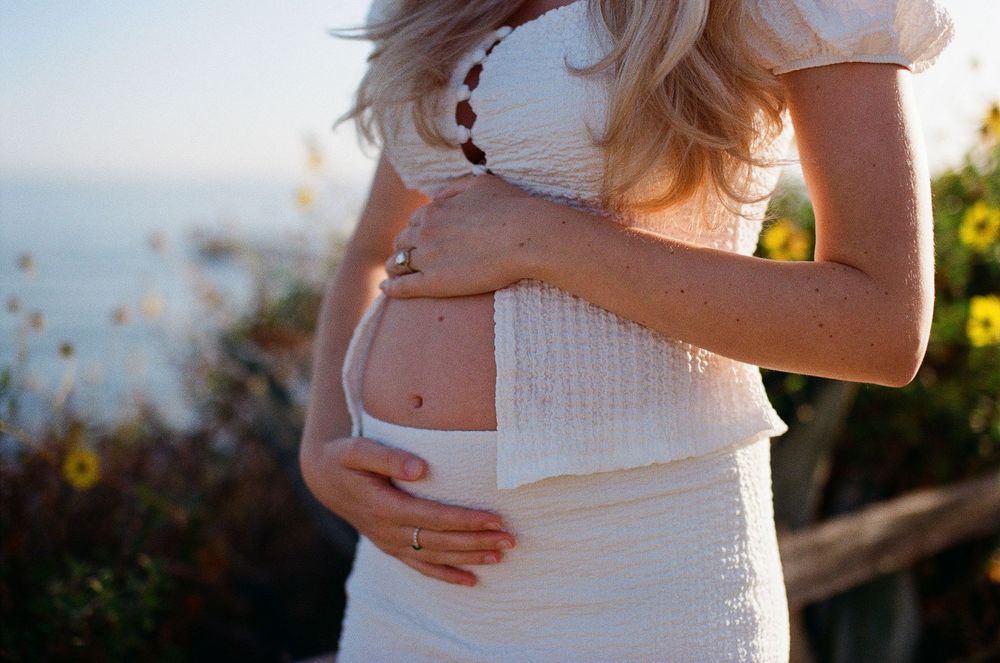 Santa Barbara maternity photographer capturing a glowing baby bump on 35mm film.